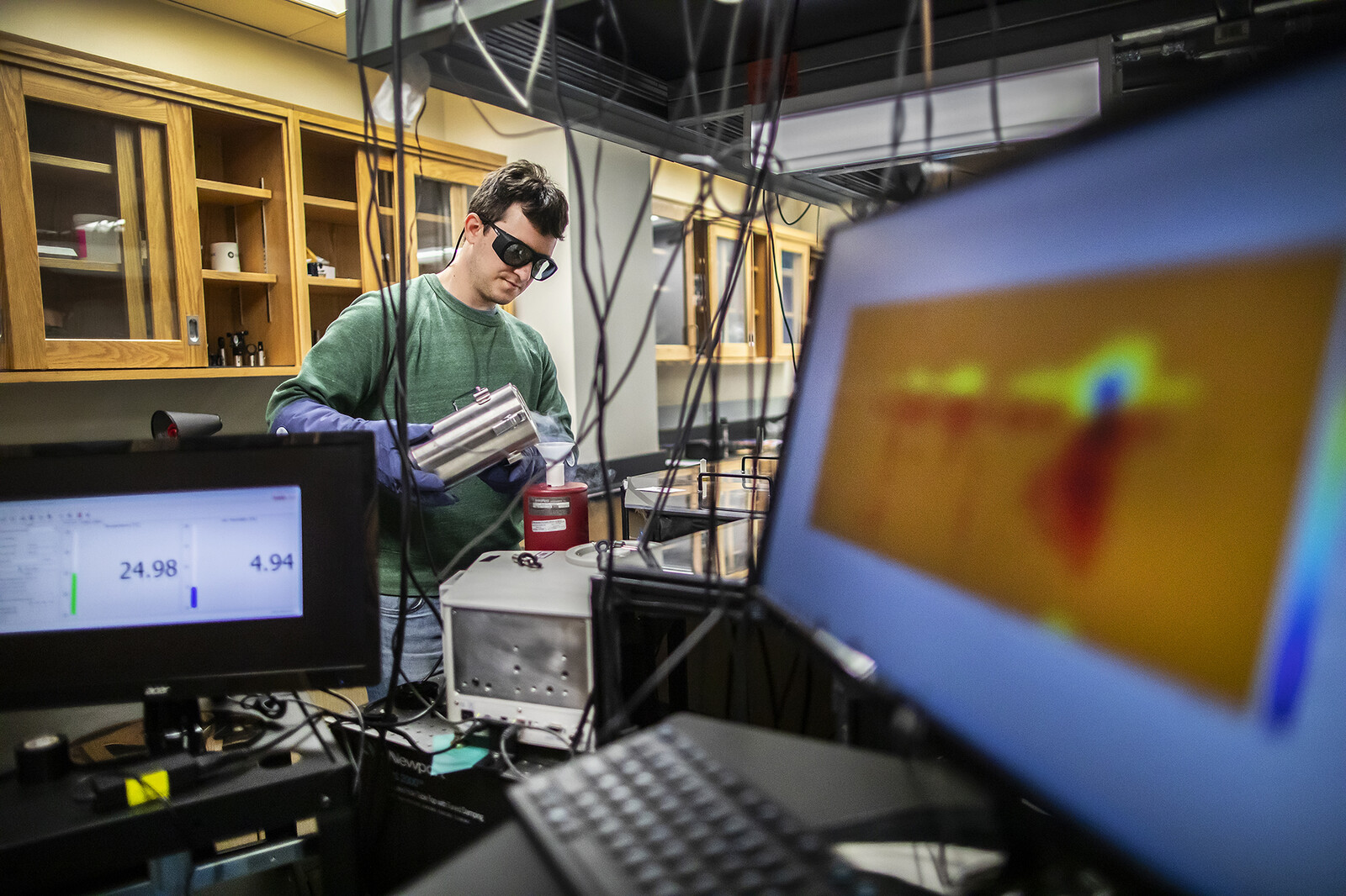 A doctoral student conducts physical chemistry research as part of the Center for Hybrid Approaches in Solar Energy to Liquid Fuels (CHASE).