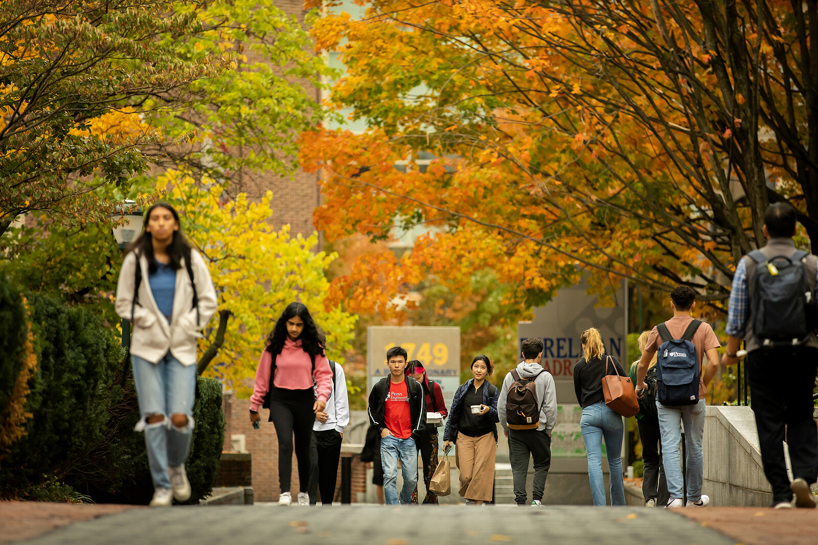 students walking in perelman quad in the fall