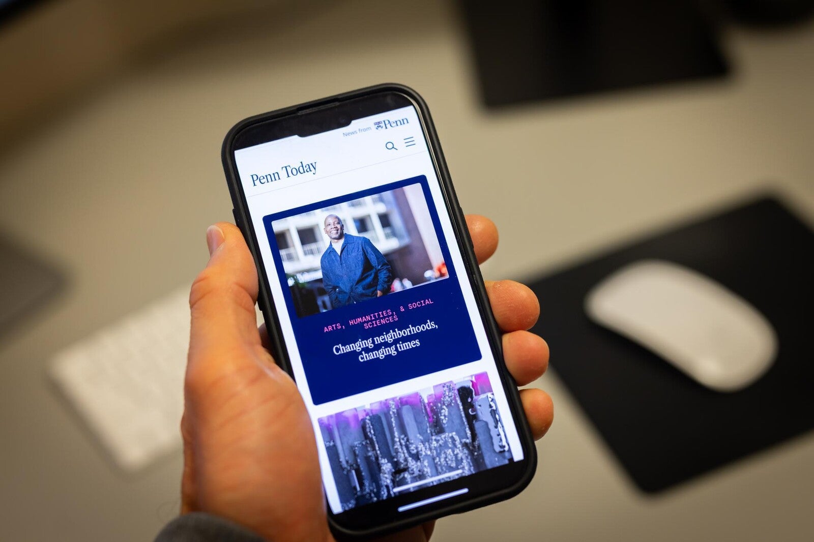 new penn today website, phone in hand