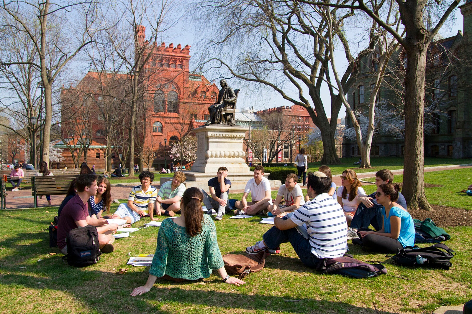 students sitting on college green