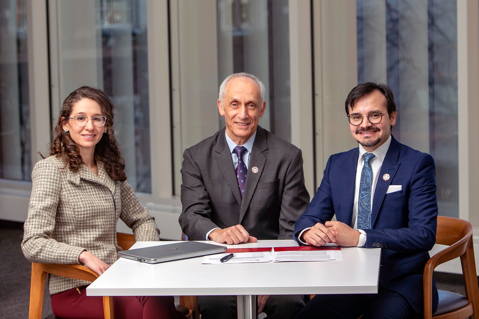 three dental association colleagues sitting at a table