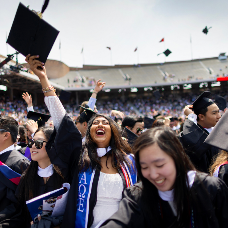 Students throwing caps in the air at commencement