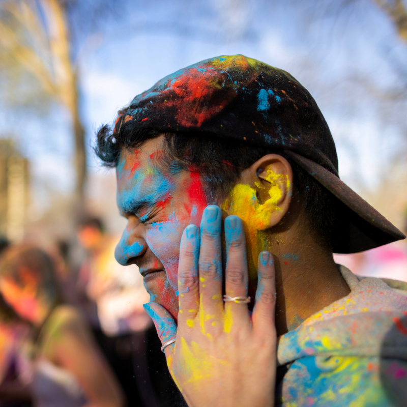 Students gathered to celebrate Holi with traditional colorful powder.