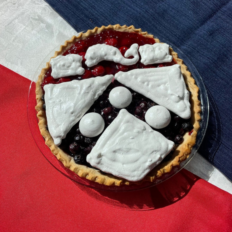 A pie baked into the shape of the University of Pennsylvania logo.